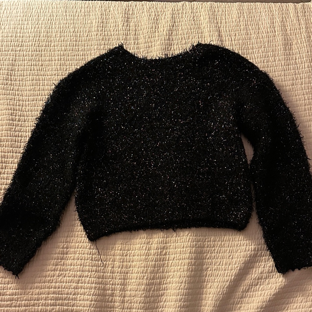 Girls black sweater with colorful tinsel.